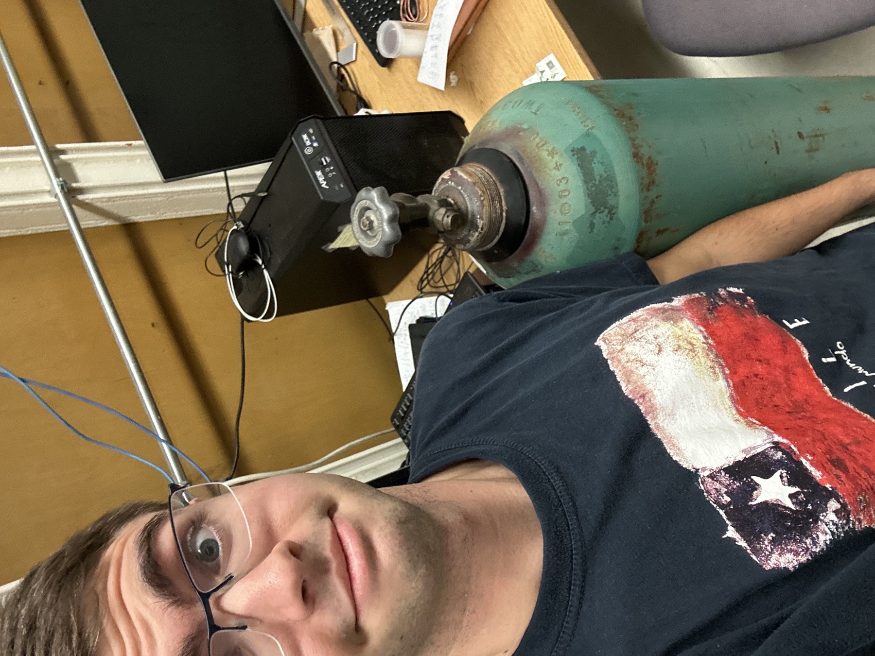 The author making a concerned face standing next to a K bottle of nitrogen