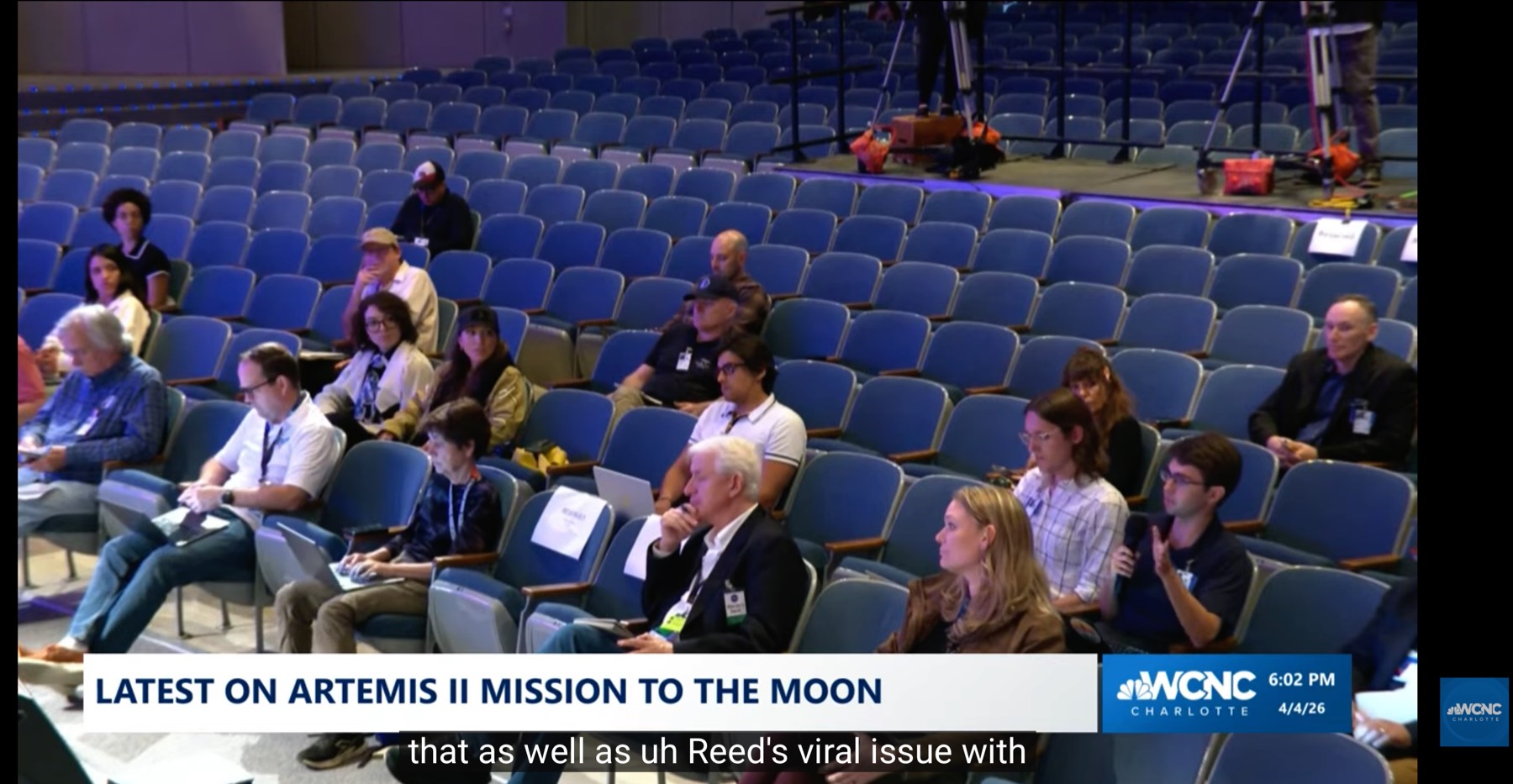 Alejandro visible in the background of a WCNC Charlotte live news segment covering Artemis II